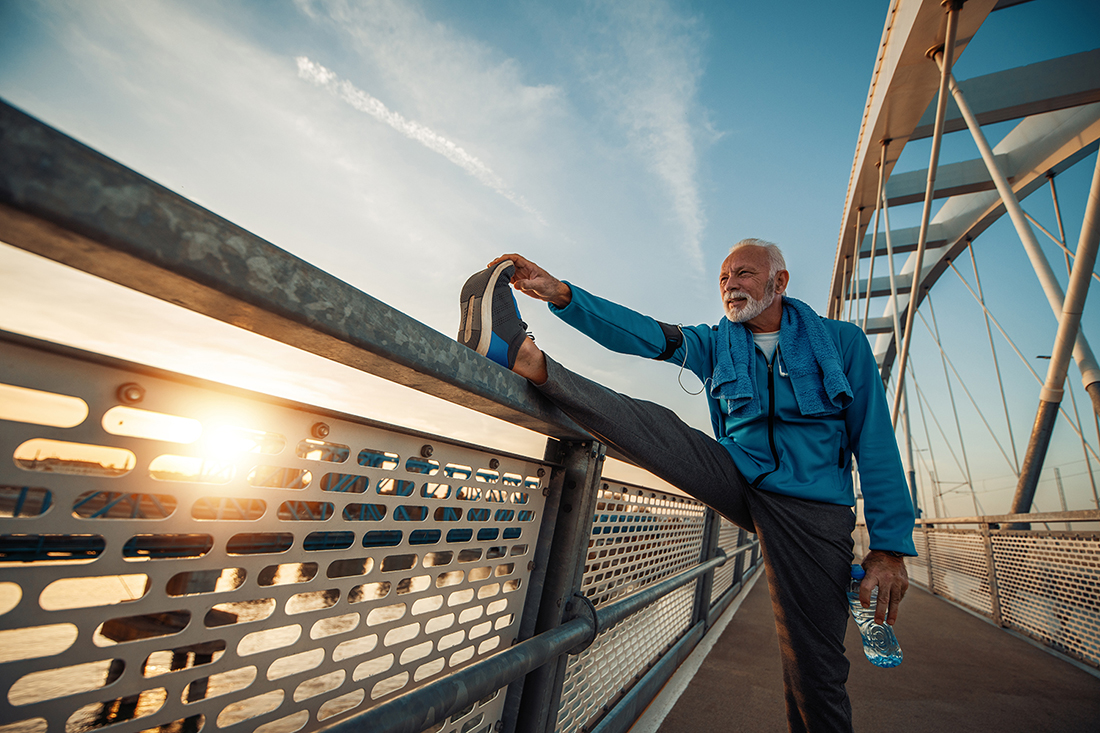 Male runner on a bridge